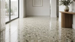 Sol en terrazzo traditionnel avec éclats de marbre et ciment, finition polie, ambiance élégante, neutre et lumineuse, réaliste.